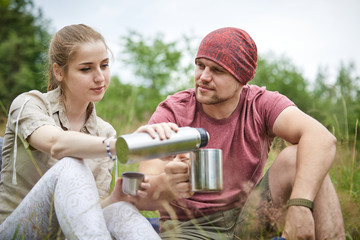 two travelers with thermos, outdoor picnic