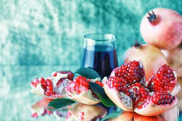 Ripe grains of pomegranate on the table. Pomegranate juice.