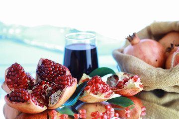 Ripe grains of pomegranate on the table. Pomegranate juice.