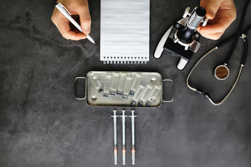 Vaccination. Disposable syringes and test tubes with medicinal vaccines on the table.