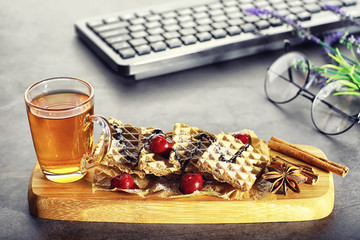 Sweet dessert with waffles and berries for tea at work.