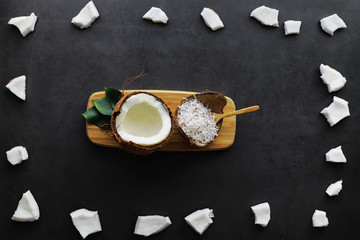 Coconut on a dark stone table. Coconut oil.