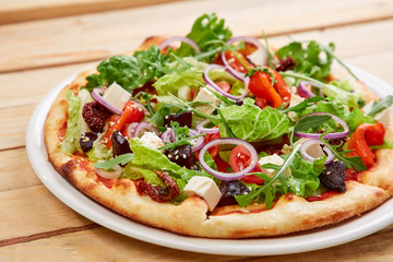 vegetarian pizza with fresh tomatoes, olives, tofu and red onion