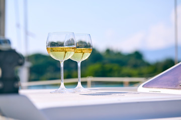 Pair of wineglasses against the yacht