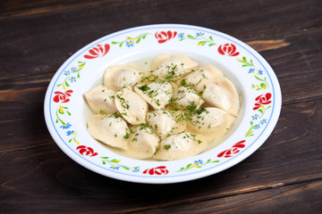 dumplings with meat on wooden background