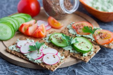 crispy rye bread with cottage cheese with herbs and seasonal vegetables sprinkled with flax seeds,delicious diet sandwiches