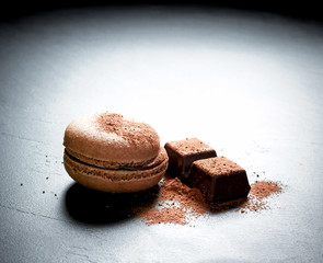 Chocolate macaron at the black background