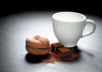 Chocolate macaron at the black background