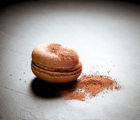 Chocolate macaron at the black background