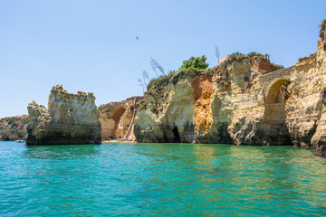 Naklejka premium Famous Rocks in Sea, Ocean, Lagos in Portugal. Popular summer travel destination and famous beach at Algarve coastline