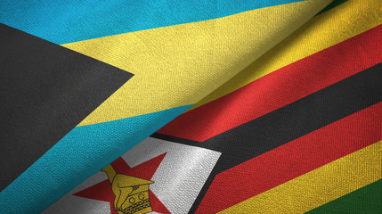 Obraz premium Bahamas and Zimbabwe two flags textile cloth, fabric texture