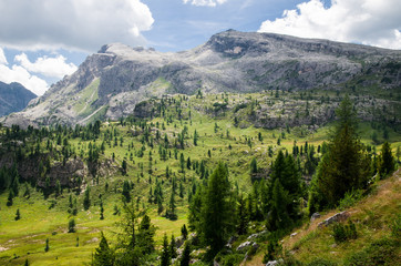 Dolomites in sunny weather with puffy clouds