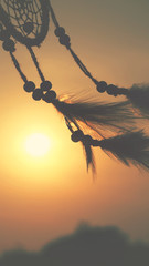 Blurred image, Dream catcher native american in the wind and blurred bright light background, hope...