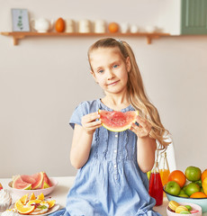 The girl eats fruit pineapple, watermelon, apples and drinks drinks from chia. Healthy food in the children's menu