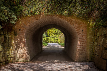 Fototapeta na wymiar Brick tunnel in city park