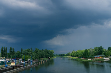 Fototapeta premium Czech river Labe (Elbe) in Pardubice with dramatic clouds