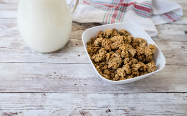 healthy breakfast. bowl with cereals and milk on wooden background