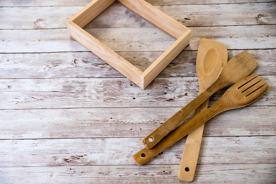 Different kind of wood utensils on wood background for cooking concept, retro tone. free space
