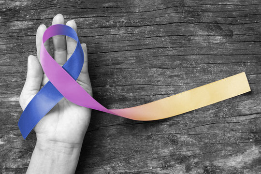 Bladder Cancer Awareness Marigold Blue Purple  Ribbon On Helping Hand Suport (isolated With Clipping Path)