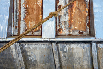 Detail of an old rusted boat to which maintenance is carried out in Urk, Netherlands.