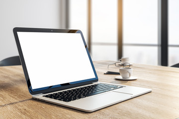 Designer desktop with white laptop
