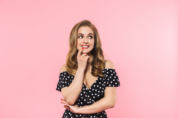 Beautiful happy young pretty woman posing isolated over pink wall background.