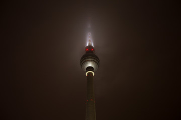 berlin tv tower in the fog at night