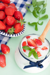 Fresh Organic Greek Yogurt with strawberries and mint leaves