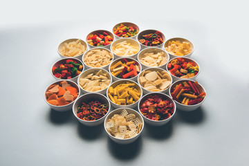 Snack pellets are non-expanded products made with raw materials like cereals, potatoes or vegetable powders, later processed using frying, hot air baking. multicoloured / shaped ready-to-eat snacks