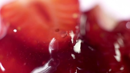 Macro strawberry jam dessert syrup pouring on moving sticky spoon. Cooking home canned confiture food. - Powered by Adobe