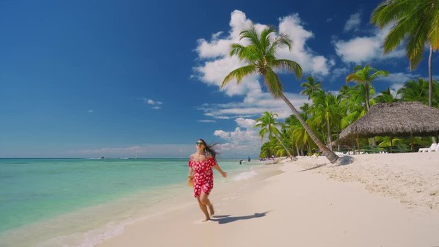 Happy carefree woman enjoying summer vacation in Caribbean islands. Punta Cana, Dominican Republic