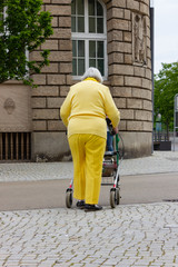 senior lady in yellow dress with rollator