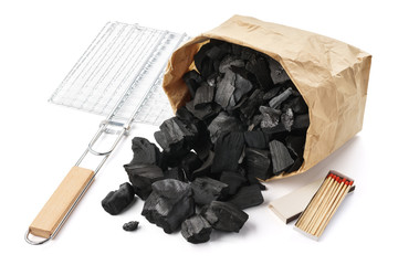 Paper bag of charcoal, grill, matches. Barbecue preparation set.