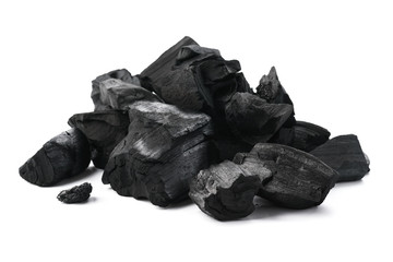 Pile of charcoal pieces isolated on white. - obrazy, fototapety, plakaty