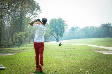 Fototapeta premium Blurred golfer playing golf in beautiful golf course in the evening golf course with sunshine in thailand