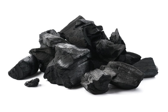 Pile of charcoal pieces isolated on white.