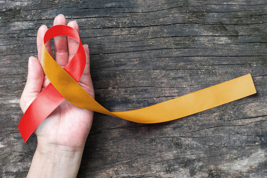 Red Gold ribbon awareness concept help campaign on people patients living with Neonatal Alloimmune Thrombocytopenia (NAIT)
