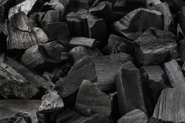 Close-up shot of natural charcoal. Black background.