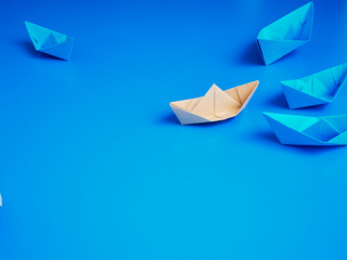 Leadership concept origami boat paper