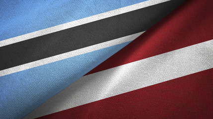 Fototapeta na wymiar Botswana and Latvia two flags textile cloth, fabric texture