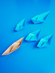 Leadership concept origami boat paper