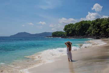 Fototapeta na wymiar Happy woman in white dress on tropical beach vacation