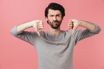 Portrait of an upset bearded man standing isolated