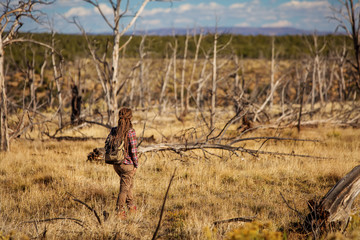 Woman in dead tree forest