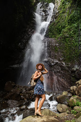 Woman near waterfal on Bali, Indonesia 