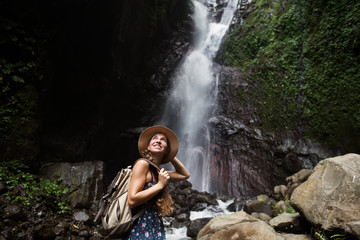Fototapeta na wymiar Woman near waterfal on Bali, Indonesia 
