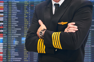 air service. Pilot in front of plane schedule in airport