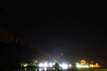 Village behind river at night, south africa