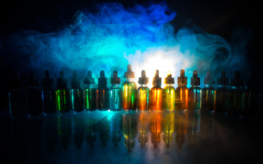 Vape concept. Smoke clouds and vape liquid bottles on dark background. Light effects. Useful as background or electronic cigarette advertisement.