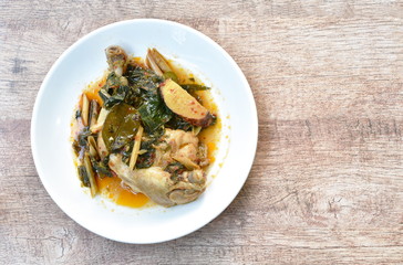 steamed spicy chicken thigh and leg with herb and chili on palte